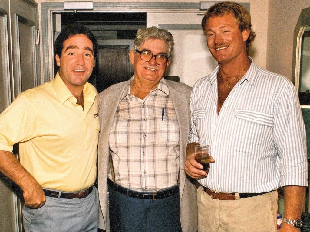 Three man standing and posing for a photo.