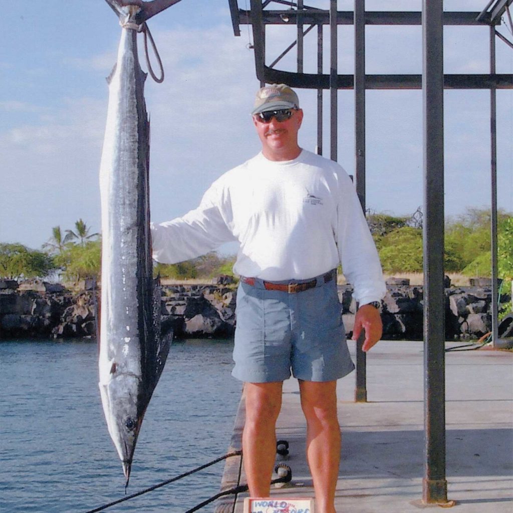 A man standing next to a shortbill spearfish.