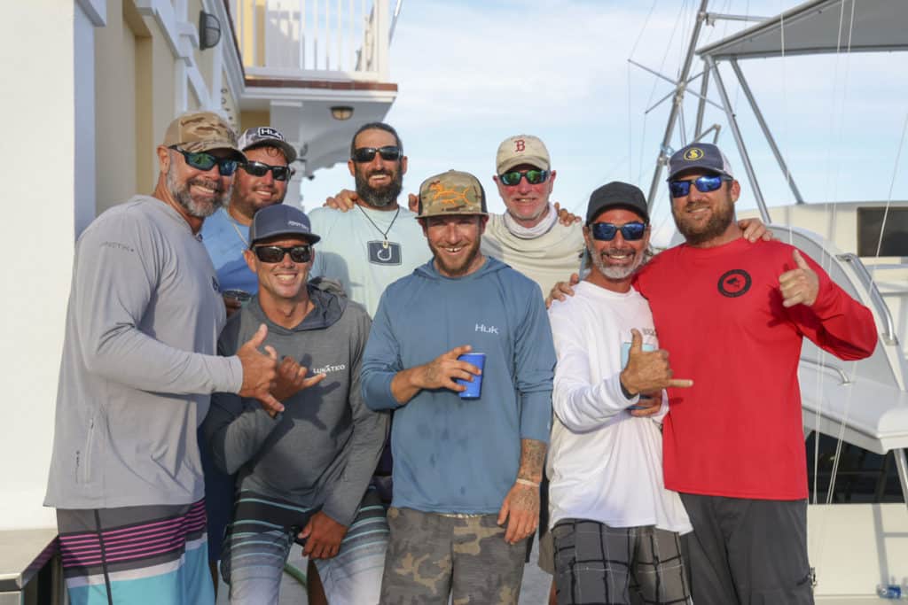 A fishing team standing and posing for the camera.