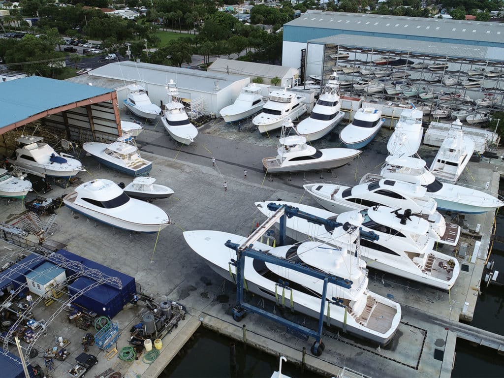A collection of sport-fishing boats and yachts in a drydock.