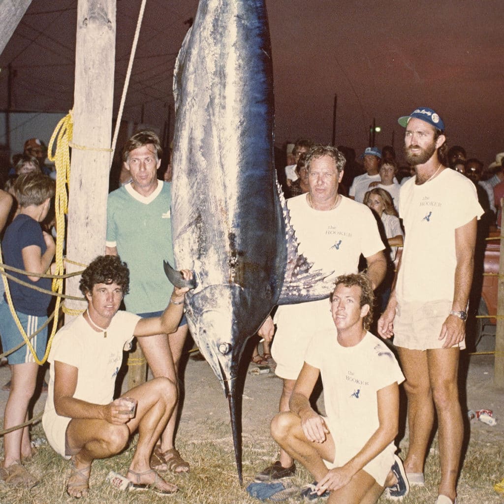 An old sepia-tone photo of a team of anglers.