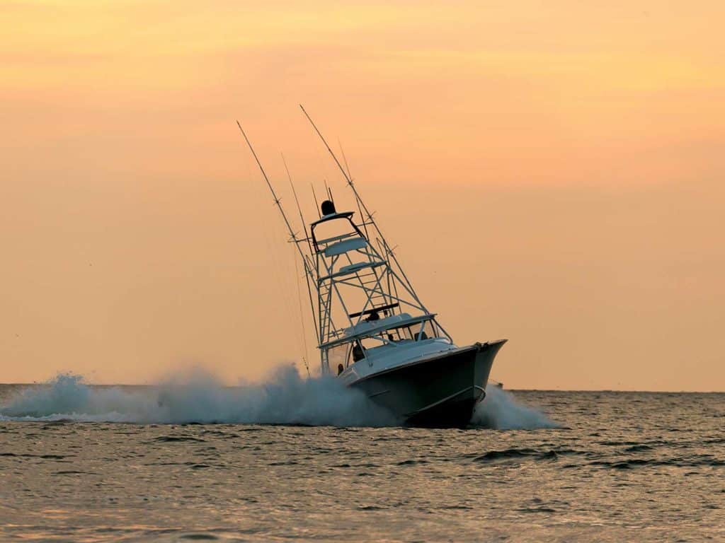 A Winter Custom Yachts 53 Express cruising on the ocean at sunset.