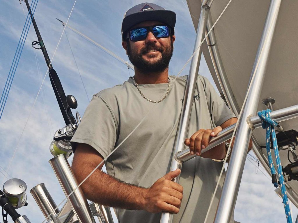 A sport-fishing captain stands on a boat deck.