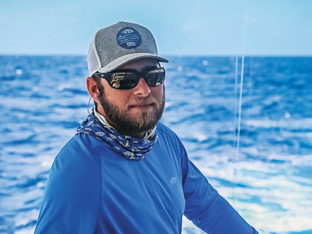 A sport-fishing captain wearing sunglasses and a cap.