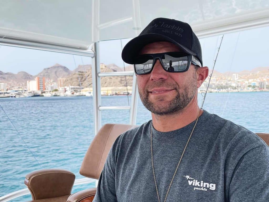 A sport-fishing captain wearing sunglasses and a cap.