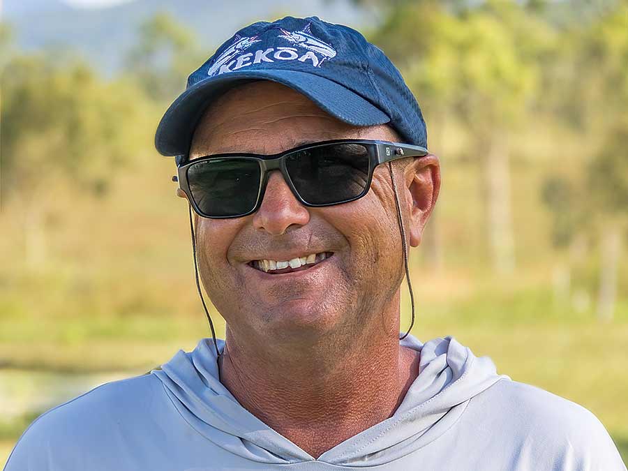 A sport-fishing captain wearing sunglasses and a cap.