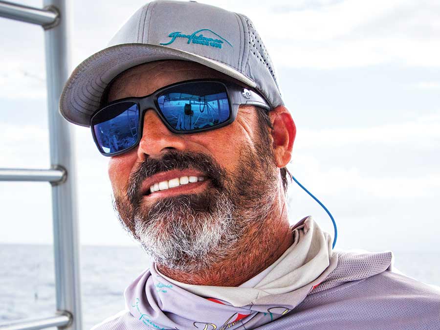 A sport-fishing captain wearing sunglasses and a cap.