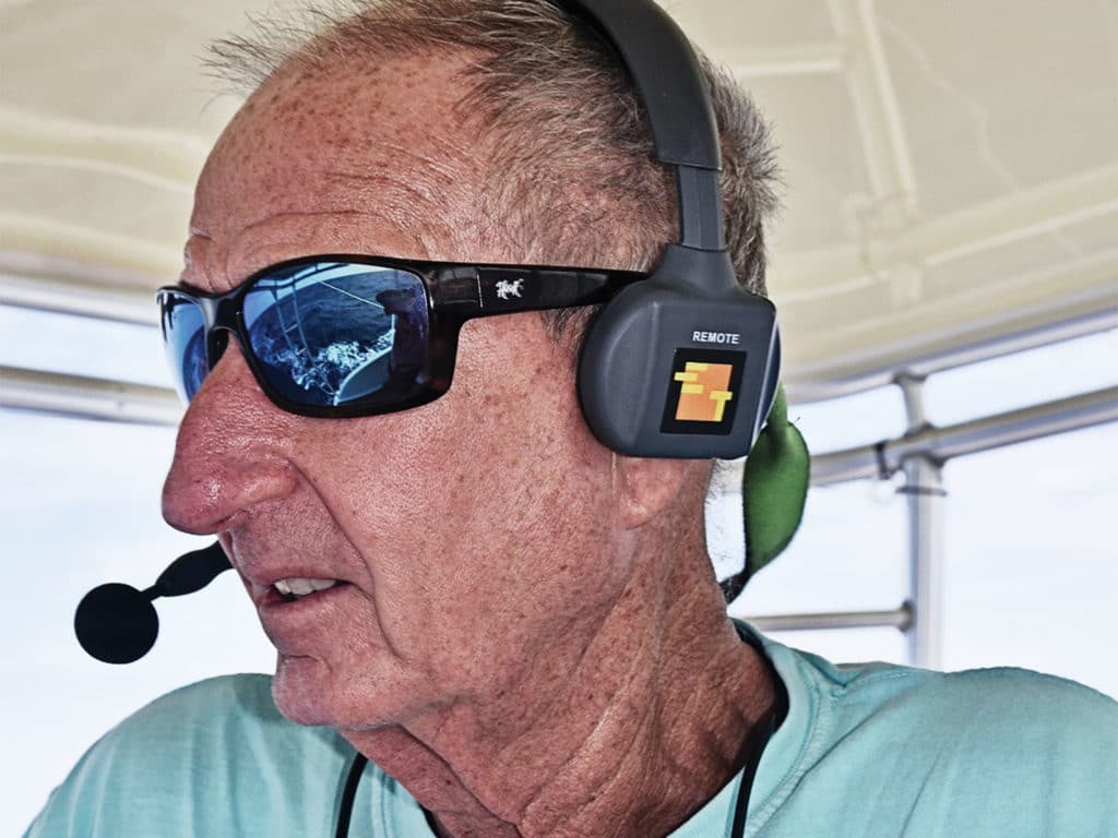 A sport-fishing captain speaking into a mic headset.