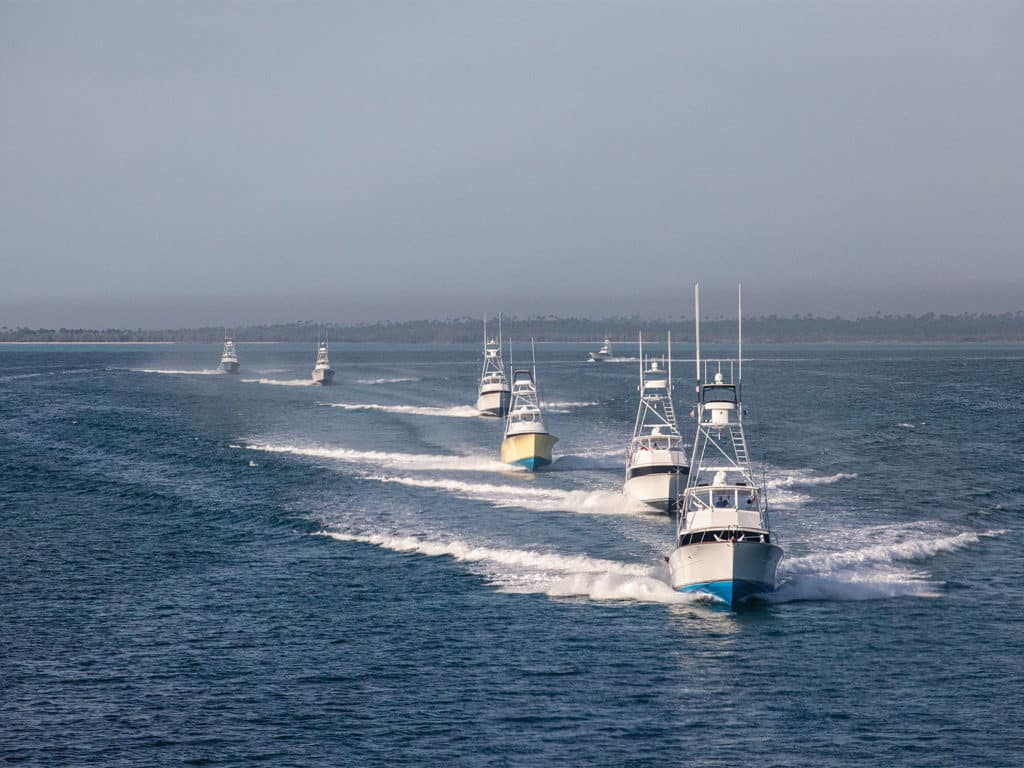 A fleet of sport-fishing boats cruising across the waters.