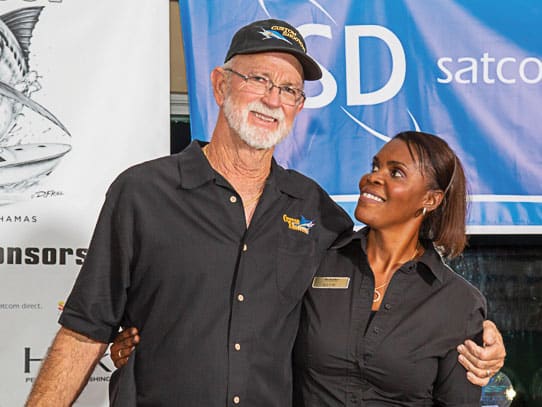 A man and woman post and smile for a picture at the Abaco Beach Resort & Boat Harbour Marina.