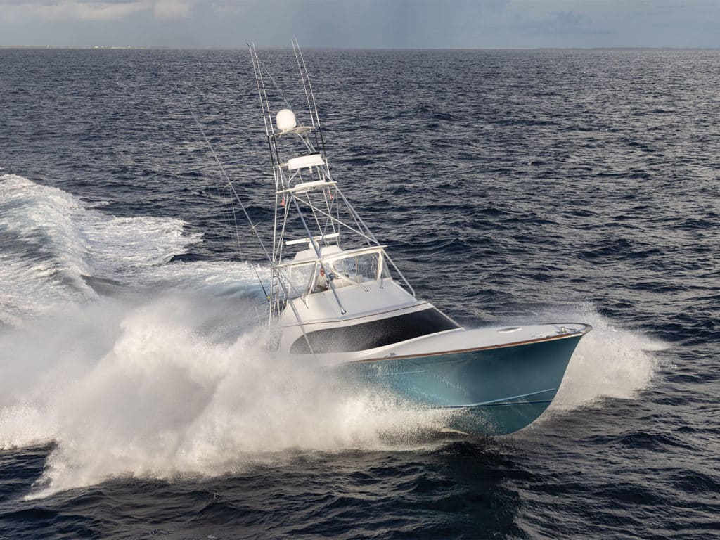 A Spencer Yachts sport-fishing boat cruises along the water.