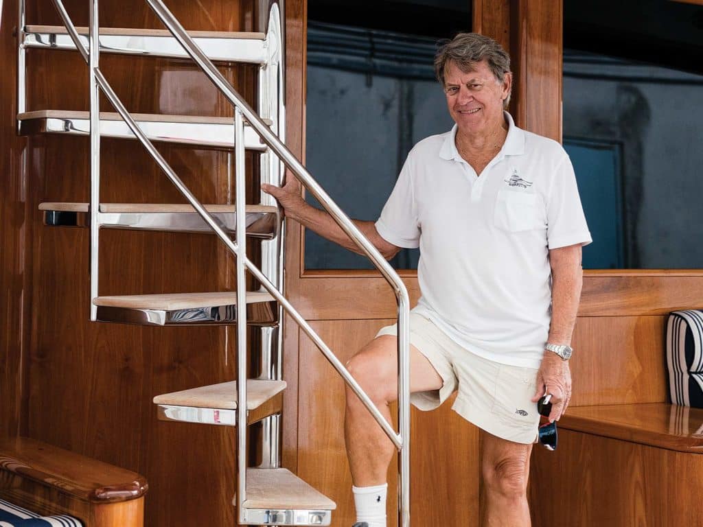 Roy Merritt standing on stairs on a sport-fishing boat.