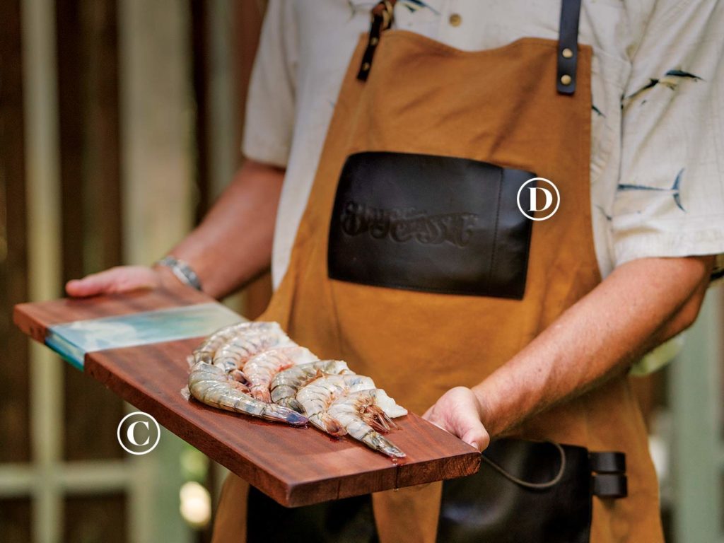 Raw Designs charcuterie boards (C) and the Bayou Classic Waxed Canvas and Leather Apron (D).