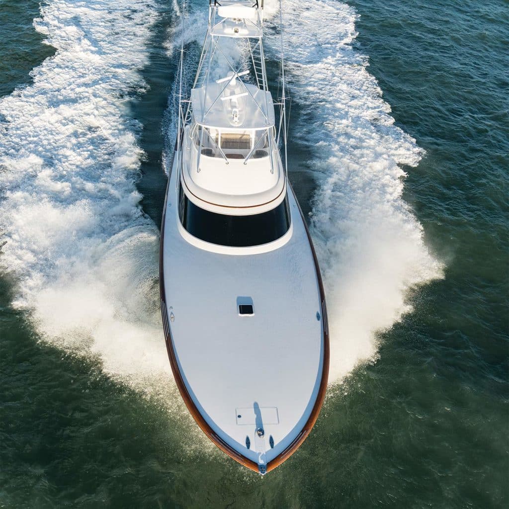 Top view of a sport-fishing boat cruising across the water.