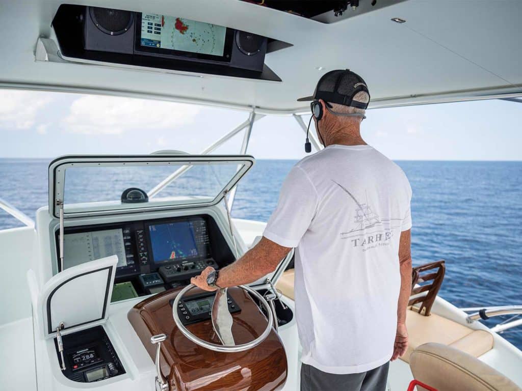 A boat captain at the helm.