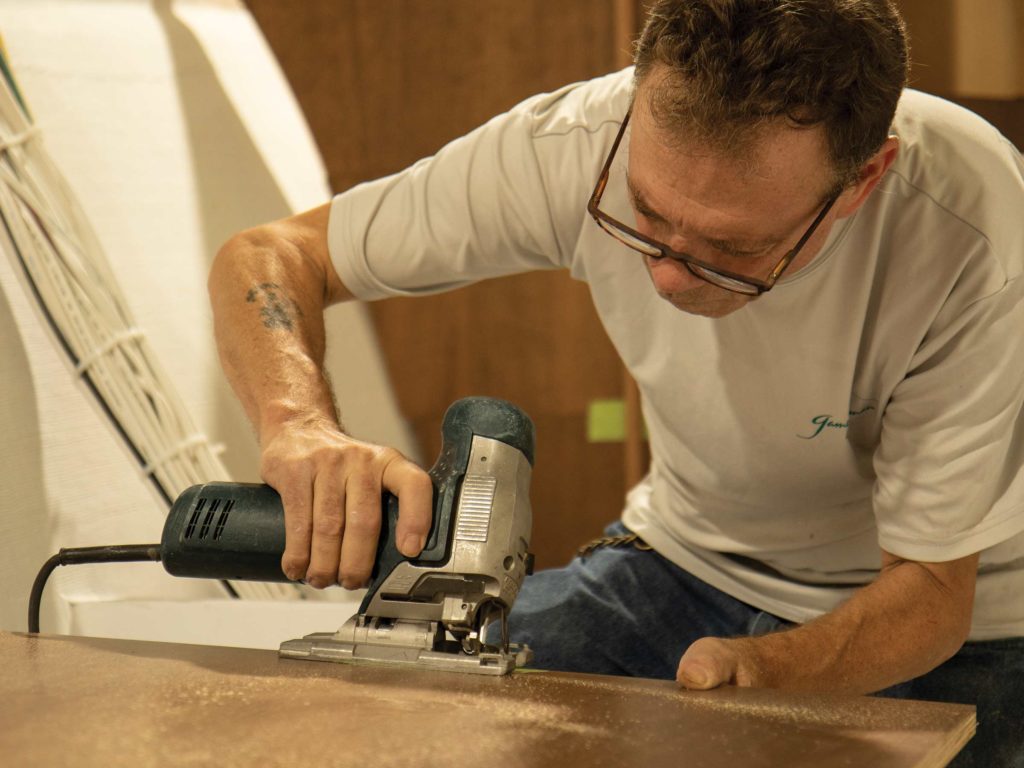 A carpenter working on a custom boat build for Gamefisherman.