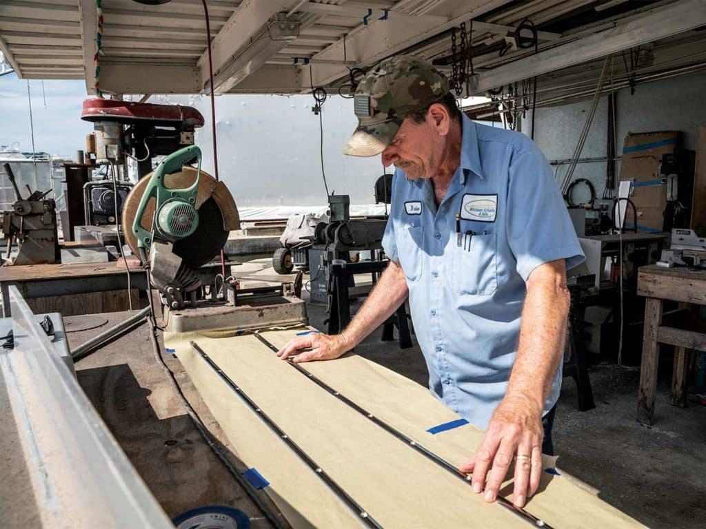 A custom boat builder of Michael Rybovich & Sons working on a custom build.