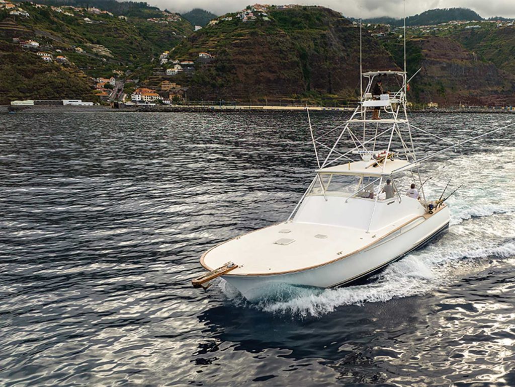 A sport-fishing boat cruising off the coast of Madeira.