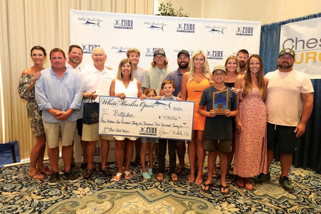 A sport-fishing team celebrating and posing at an awards ceremony.