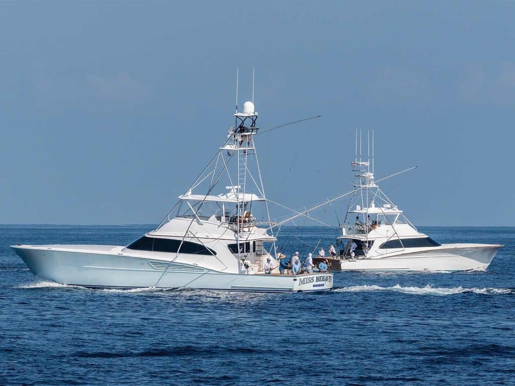 Two sport-fishing yachts cruising on the water.