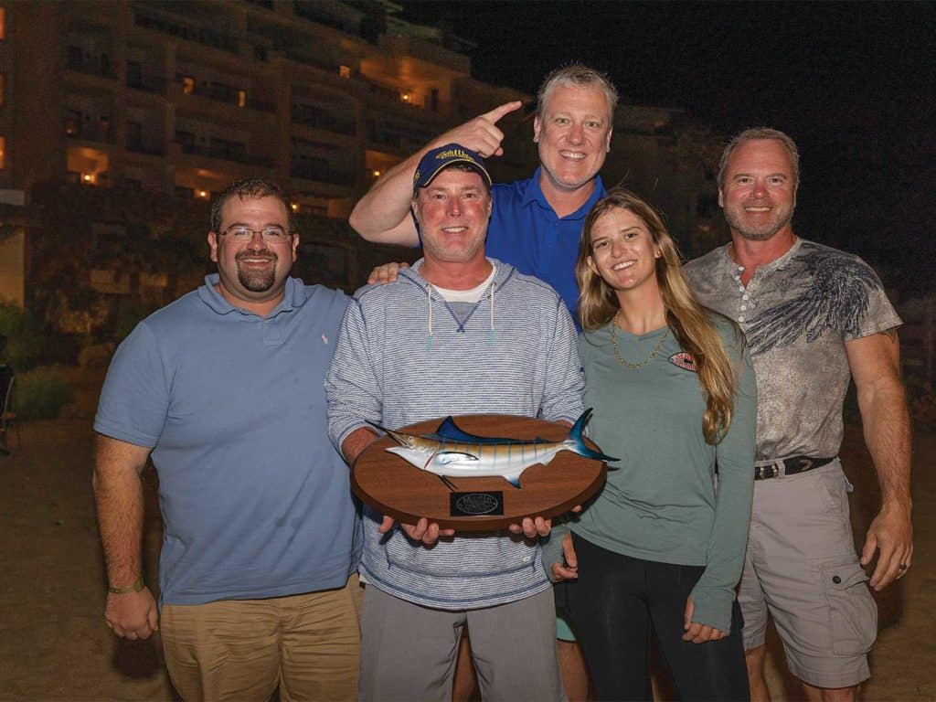 A group of 5 people standing after awards.