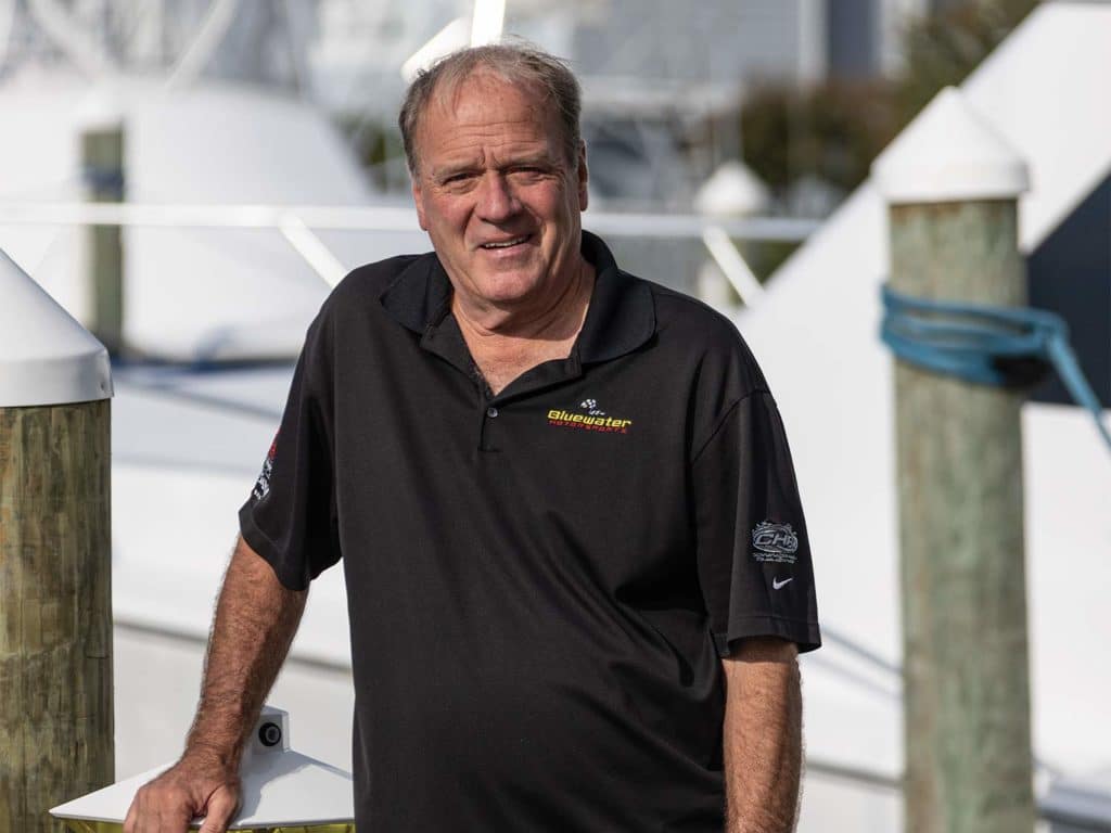 Earle Hall standing on the deck of a marina.