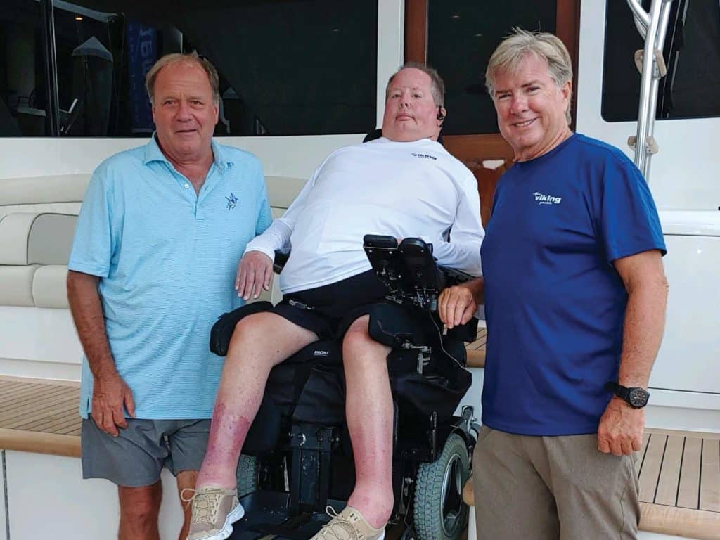 Three men in the mezzanine of a sport-fishing yacht.