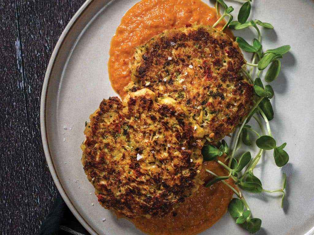 Two grouper patties on a plate.