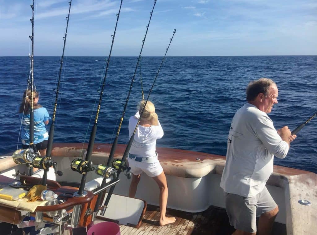 A family sport-fishing at sea.