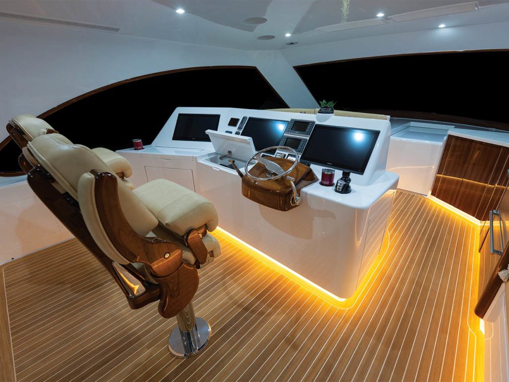 The helm and bridge of a sport-fishing boat, with LED trim around the helm.