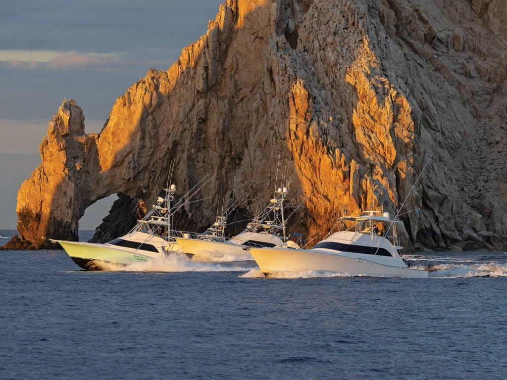sport-fishing boats cruising across the waters in front of El Arco