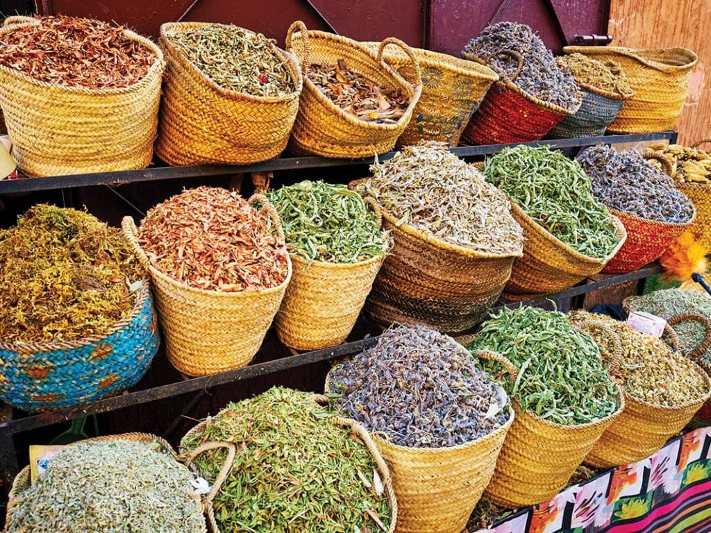 Buckets of spices and herbs in a moroccan market.