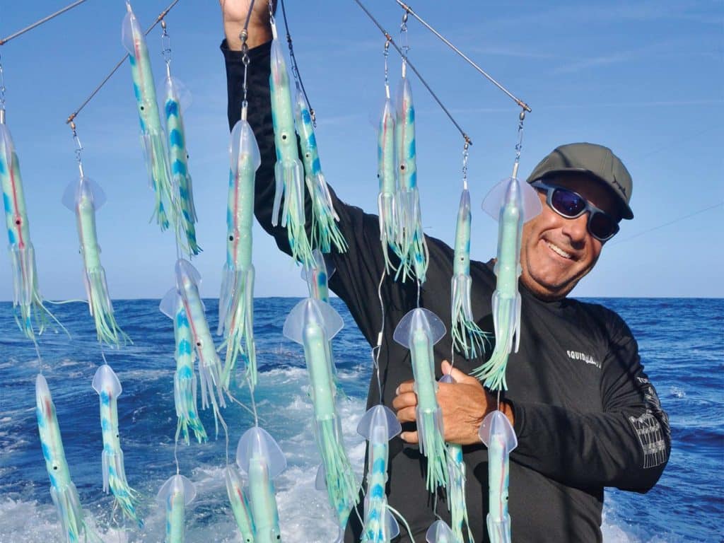 Bill Pino holding up a prototype dredge.