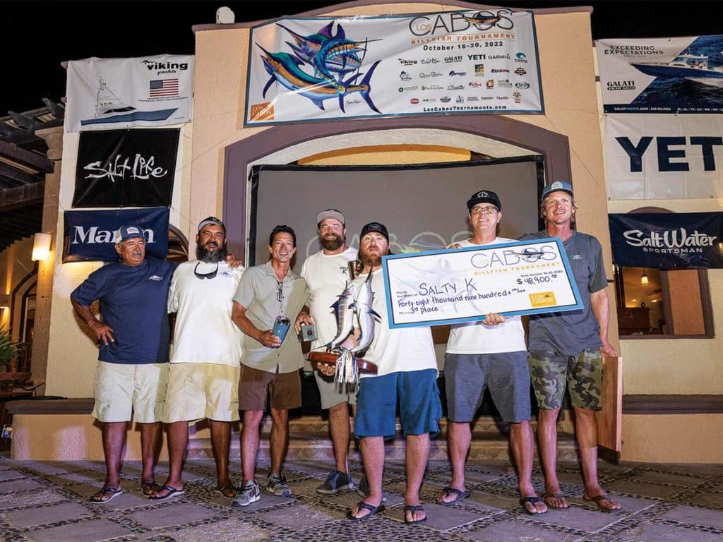 A sport-fishing team celebrating at an awards show.