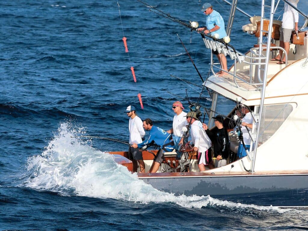 A team of fishers in heavy fishing mode on the open ocean.