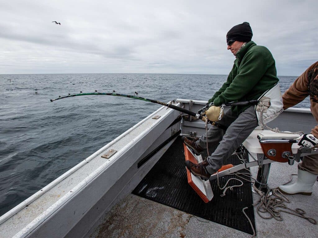 A portrait of a man fishing at sea.