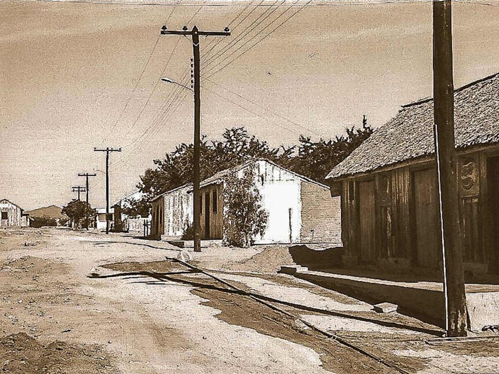 A sepia-toned image of a dusty thoroughfare.