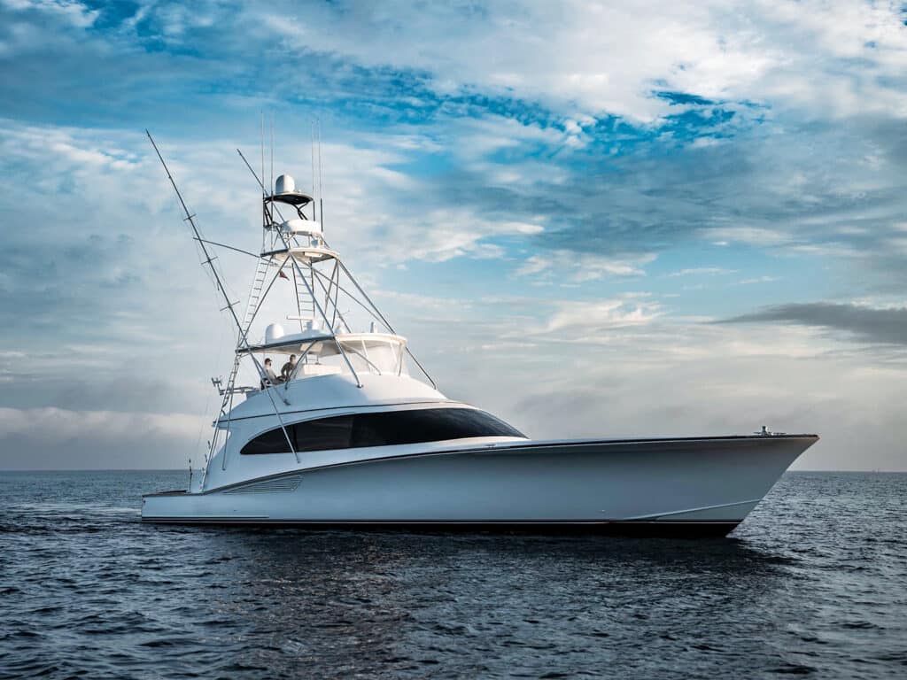 F&S Boatworks 82 sport-fishing boat cruising across the water with clear skies on the horizon.