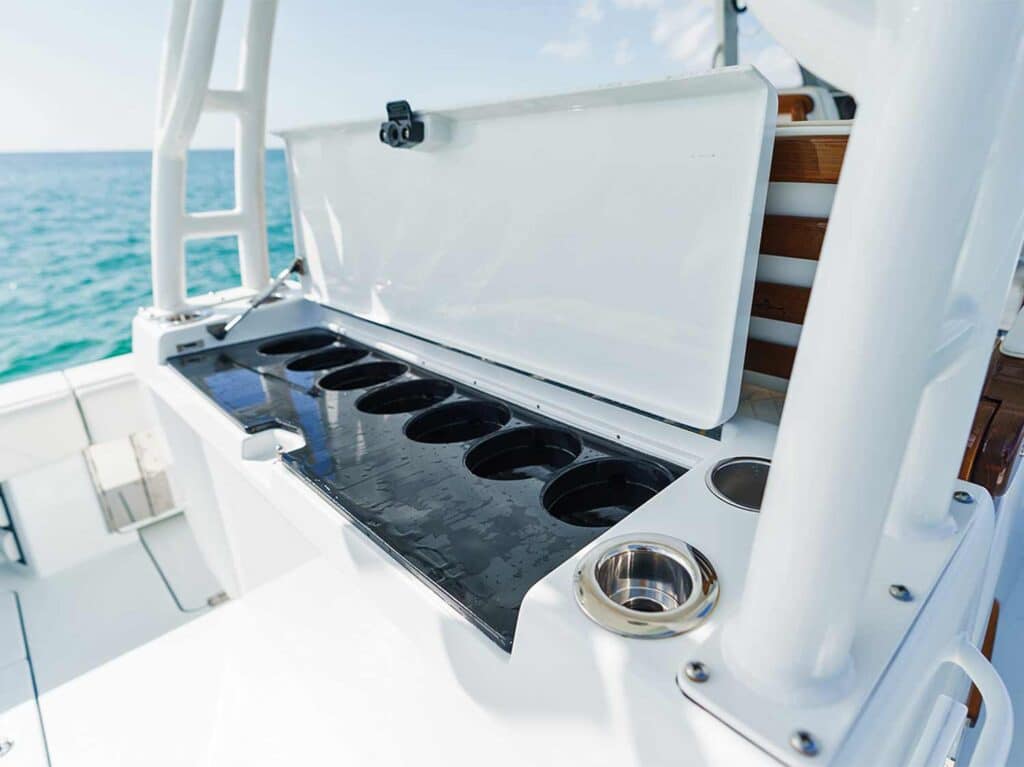 An open lid reveals the custom tuna tubes in the leaning post of a sport-fishing boat.