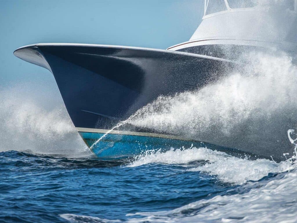 A boat hull crashing through the waves of the ocean.