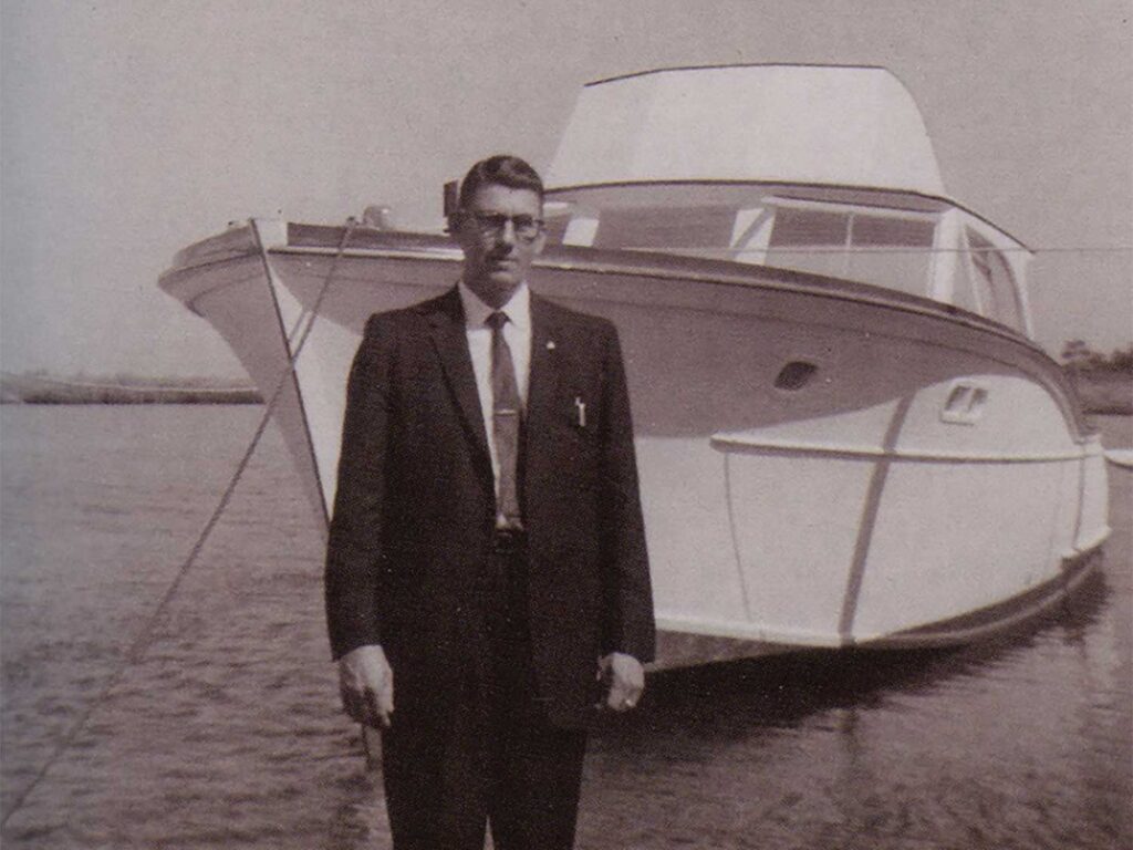 A black and white photo of a boat captain unveiling a sport-fishing boat.