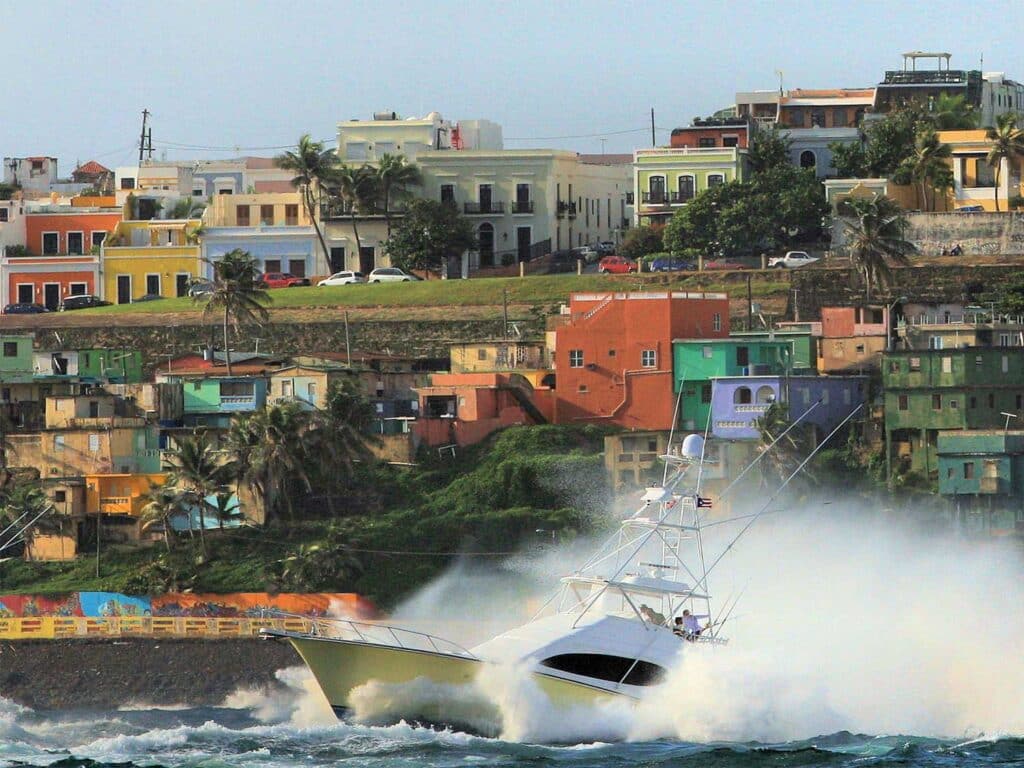 A sport-fishing boat cruises across the San Juan coastline.