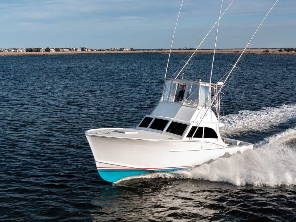 A sport-fishing boat cruises across the water.