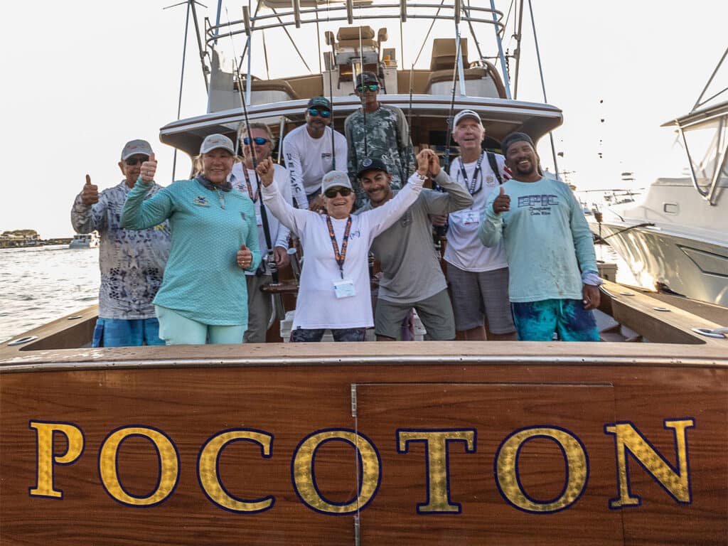 A sport-fishing team celebrating in the cockpit of their sport-fishing boat.