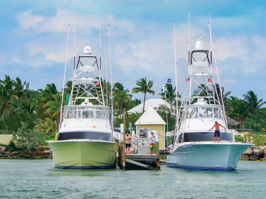 Two sport-fishing boats docked at a personal boat dock.
