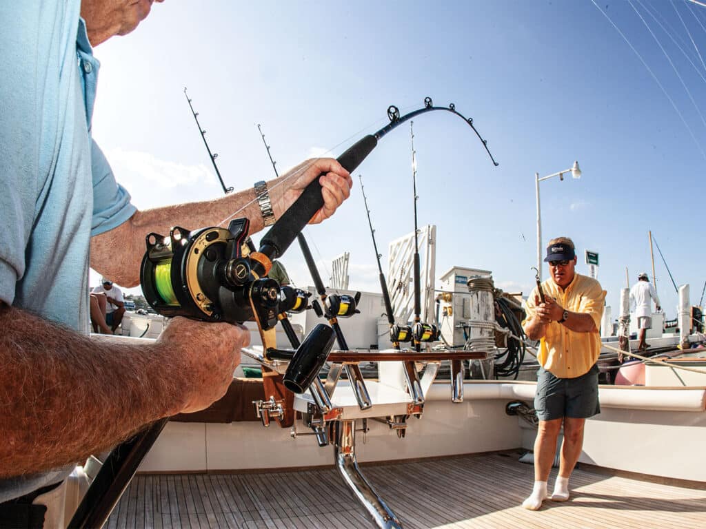 Two anglers testing fishing gear before a tournament.