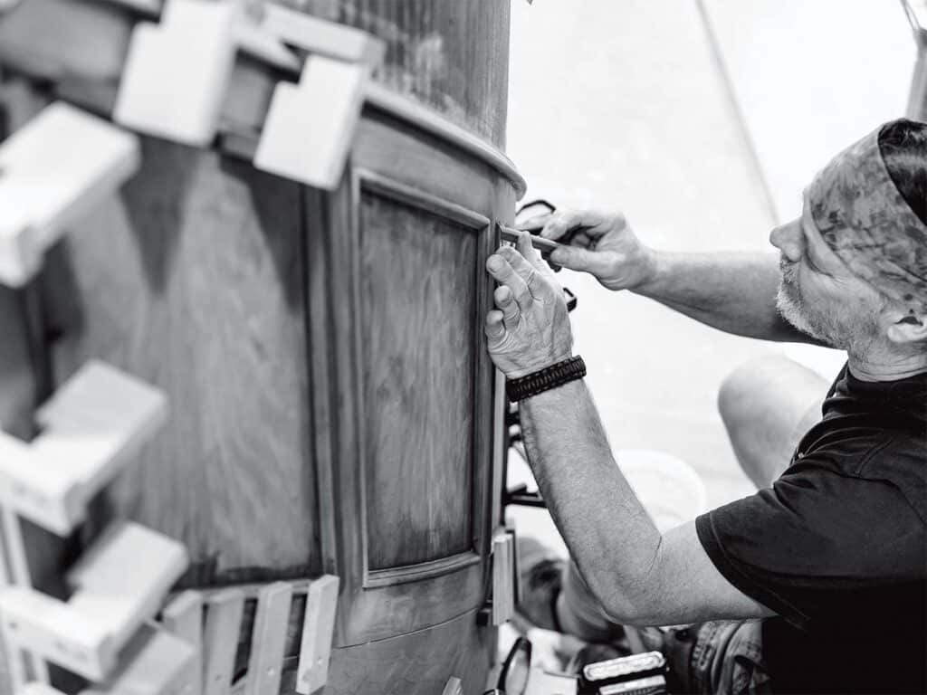 A boat crafter working on the wordwork.