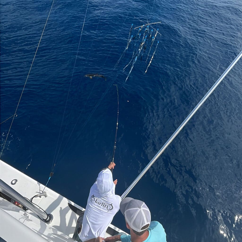 Angler throwing a dredge in the water.