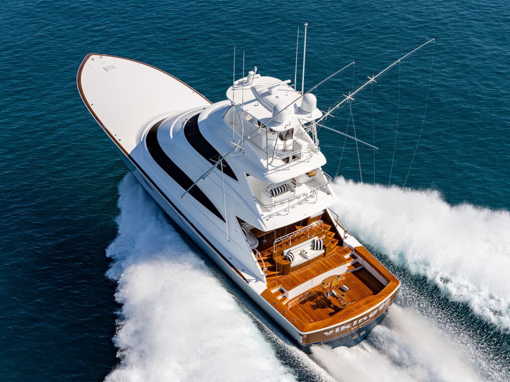 Rear view of the Viking Yacht 90 sport-fishing boat cruising over the ocean.