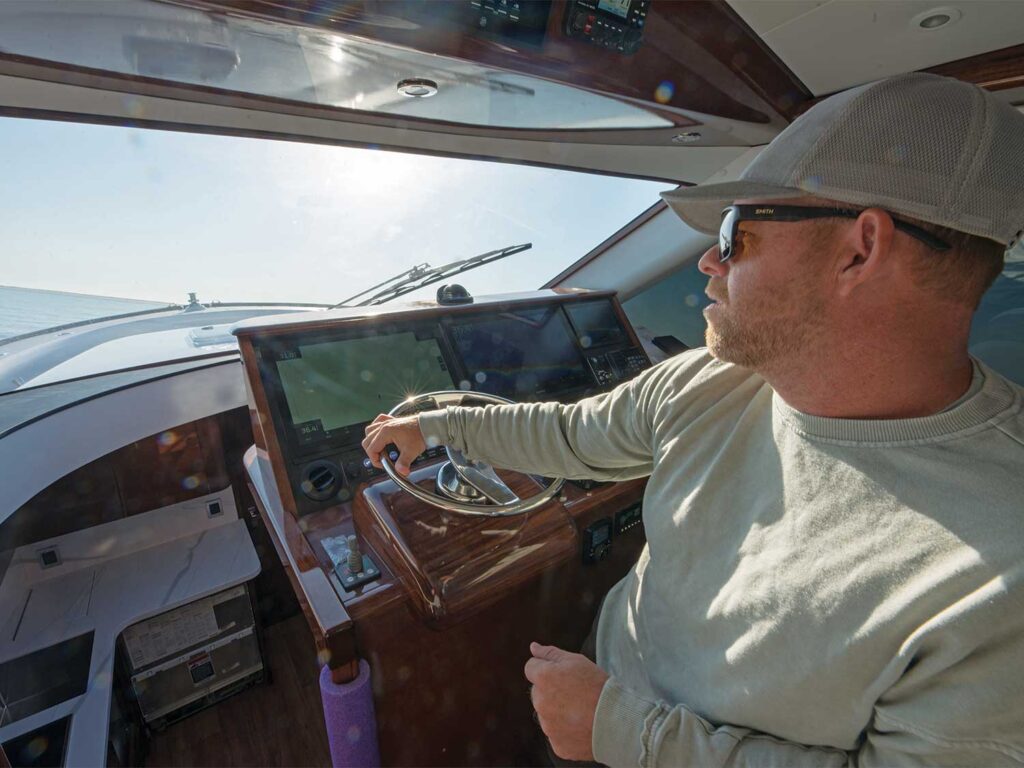 Tim Winters piloting a sport-fishing boat across the waters.